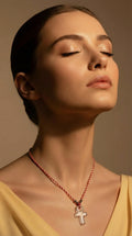 A delicate handmade necklace featuring a clear crystal cross pendant on an adjustable red cord. Simple, meaningful, and full of intention — this piece symbolizes faith, protection, and clarity. Perfect for everyday wear or as a thoughtful gift for someone special.

Each necklace is handcrafted with love, making every piece unique.
